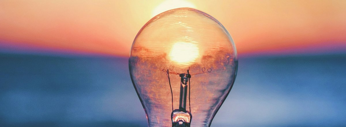 Decorative element: Lightbulb in front of sunset