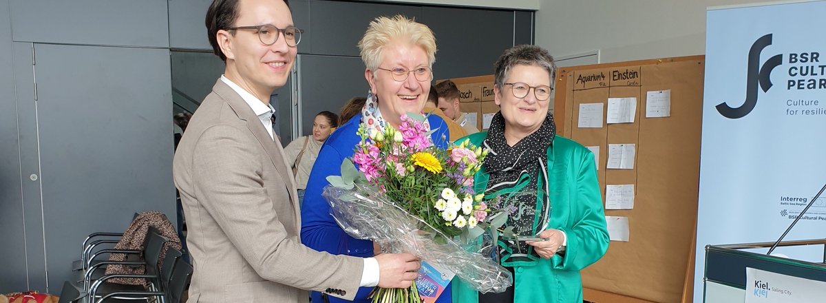 Representatives from CBSS and Kiel with the BSR Cultural Pearls trophy and a flower bouquet